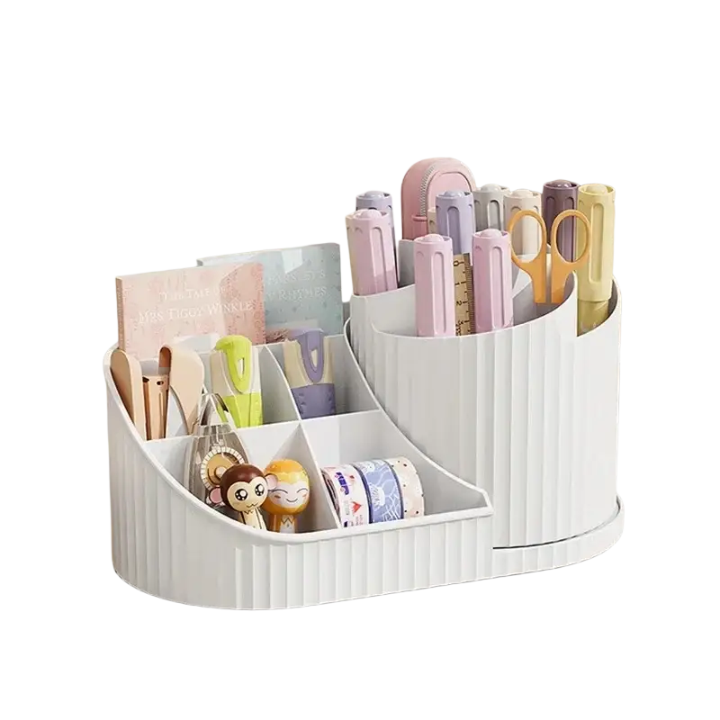 White ribbed plastic rotating makeup organizer with multiple compartments holding pens scissors washi tape and figurines