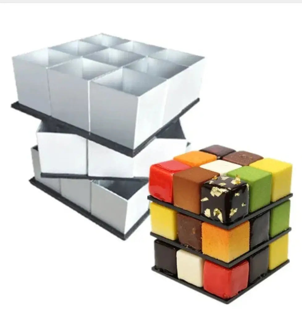 Colorful rubiks cube shaped dessert made with a 9-cavity silicone mousse baking mold featuring multicolored chocolate and gold leaf accents