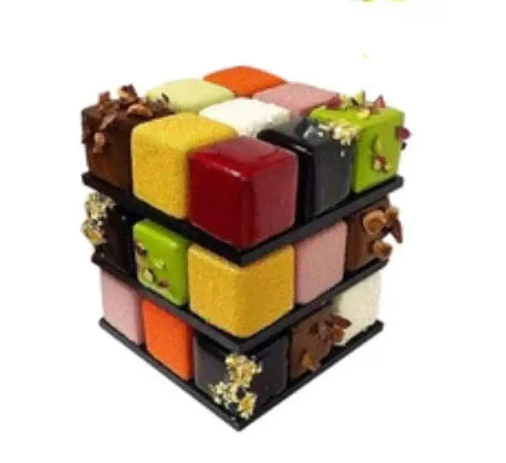 A vibrant three-dimensional cube dessert made with a 9-cavity rubiks cube silicone mousse baking mold featuring colorful segments