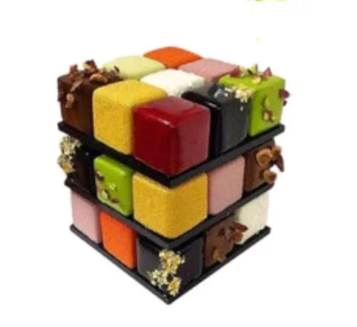 A vibrant three-dimensional cube dessert made with a 9-cavity rubiks cube silicone mousse baking mold featuring colorful segments