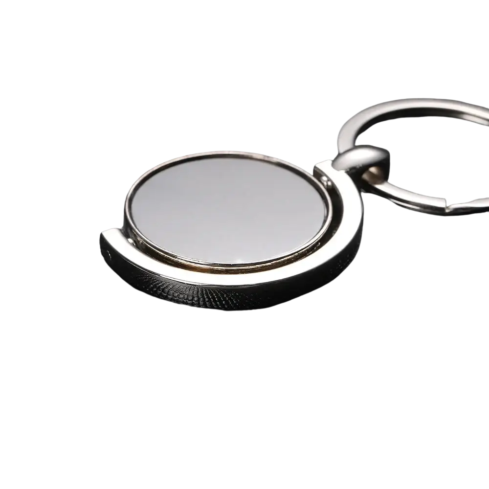 Rotating silver circle keychain featuring a circular reflective face and polished metal rings for gifting