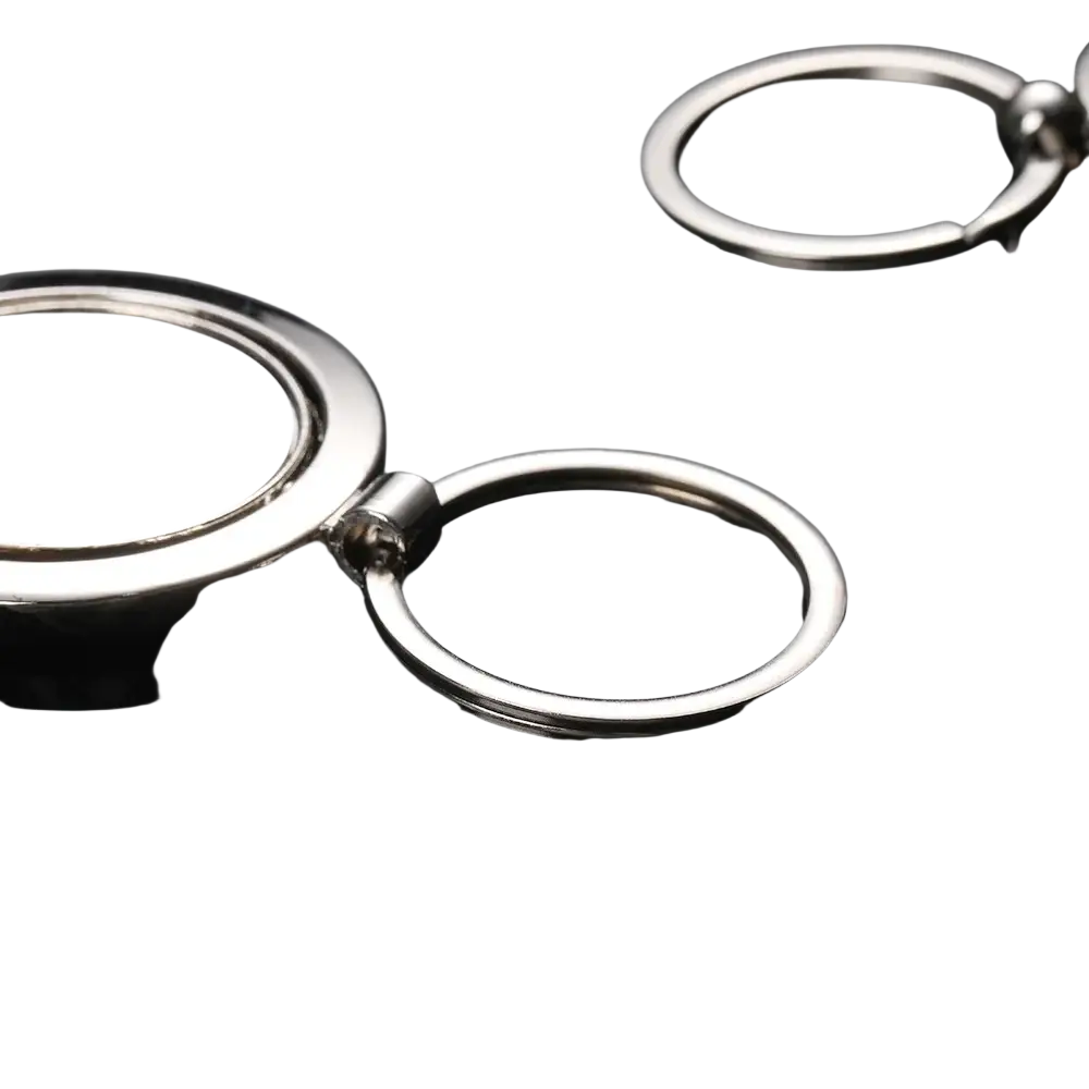 Rotating silver circle keychain featuring a silver metallic flat disc attached to a ring by a hinge mechanism