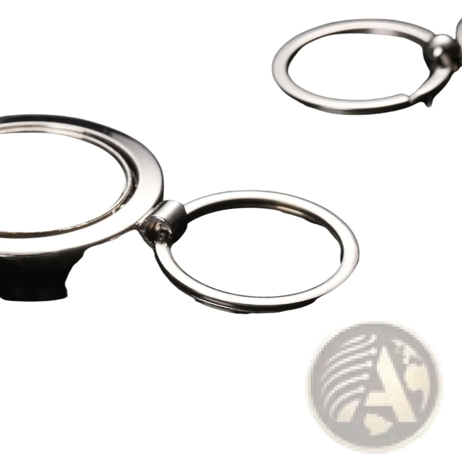 Rotating silver circle keychain featuring a silver metallic flat disc attached to a ring by a hinge mechanism