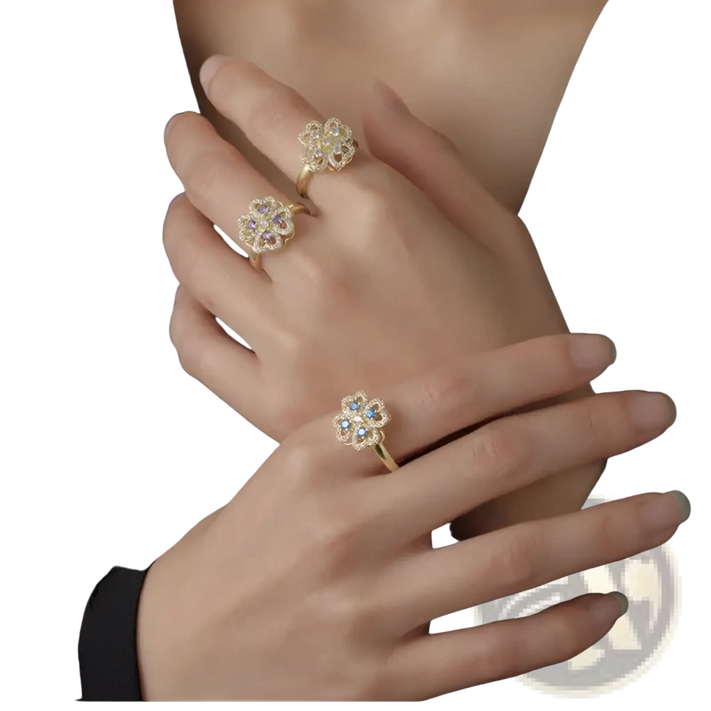 Gold-toned rotating zircon four leaf clover adjustable ring with flower shape adorned with clear and blue gemstones