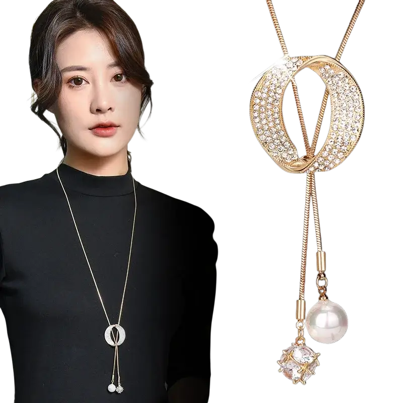 Gold-toned round circle pendant necklace with crystal-encrusted pendant and dangling pearl and gemstone charms