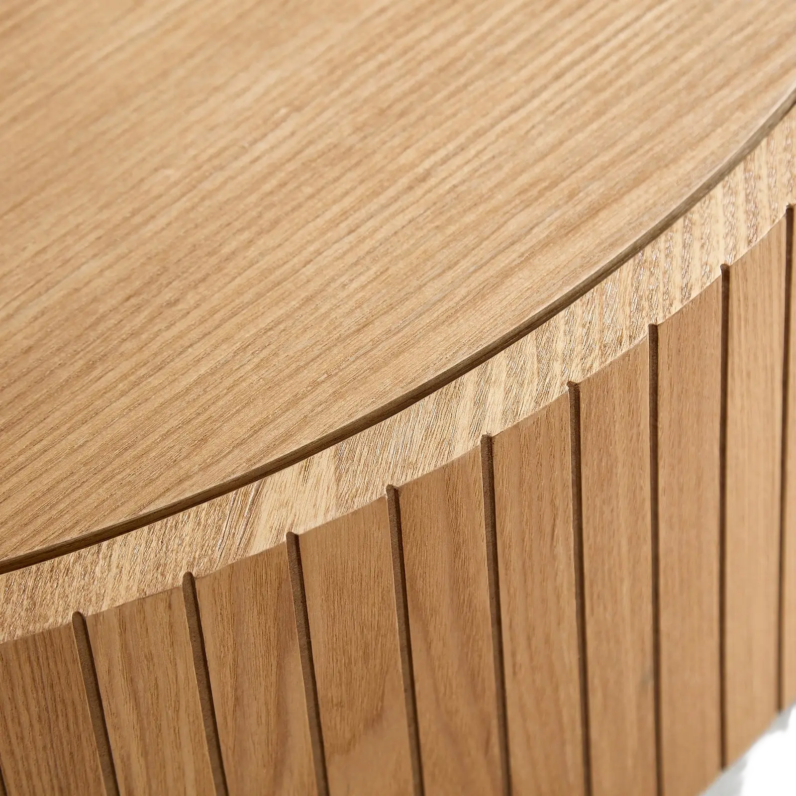 Round coffee table with storage in light oak wood featuring a smooth rounded top and vertical slat detailing