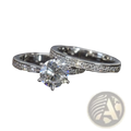 A sparkling round cut zircon wedding ring set in white gold finish with a central stone and pavé-set band diamonds