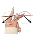 Pink round frame sunglasses with clear lenses, black temple tips, and floral clasp for fashionable outfits and applicable scenarios