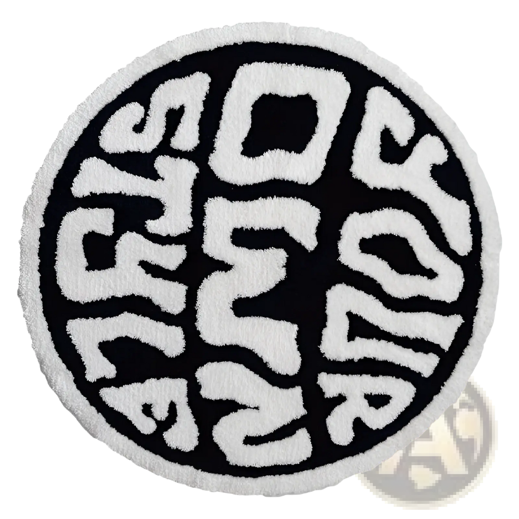 Round plush black and white rug with a textured surface featuring bold stylized lettering for minimalist decor