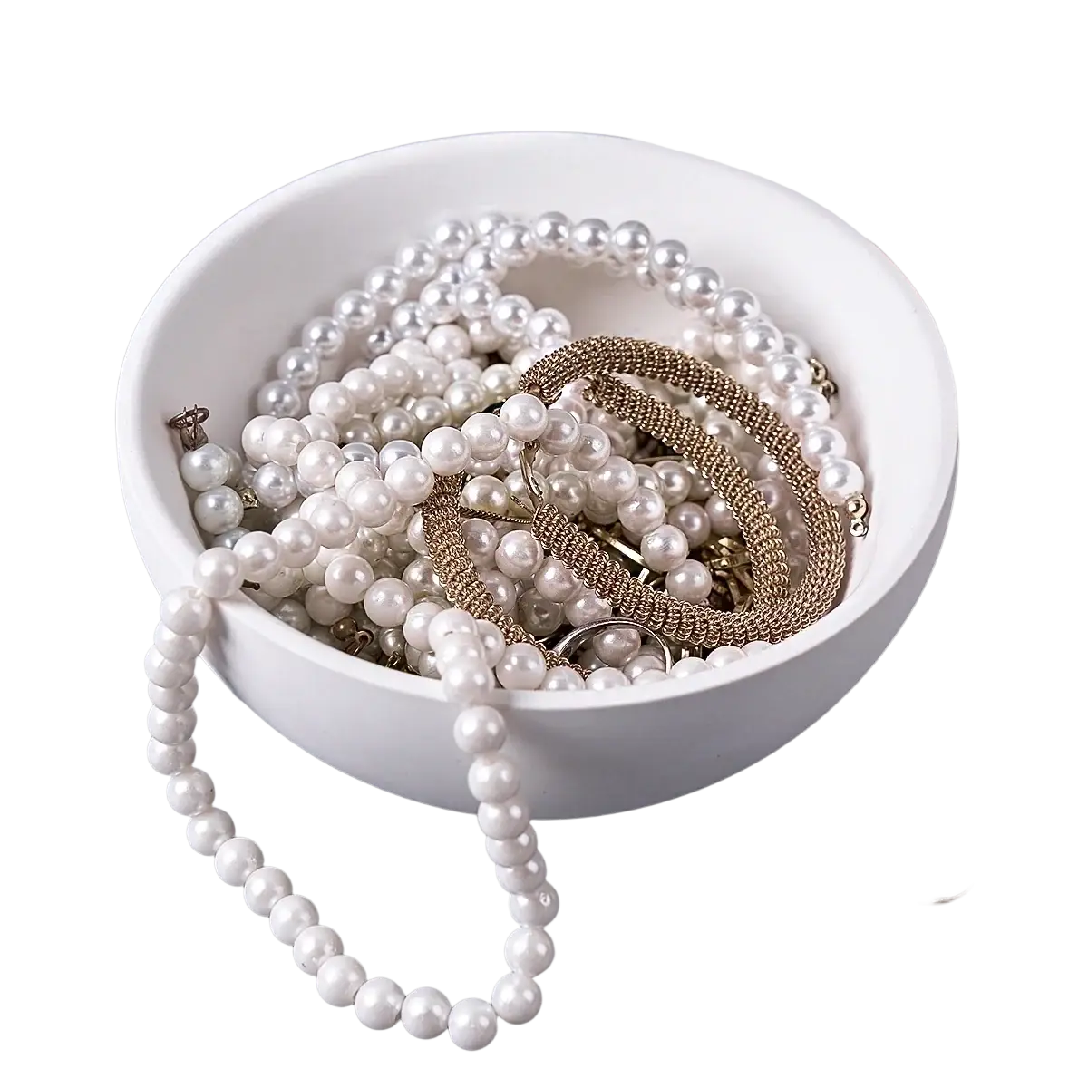 Round silicone mold in white used to create concrete storage bowls holding pearl necklaces and gold metal bracelets