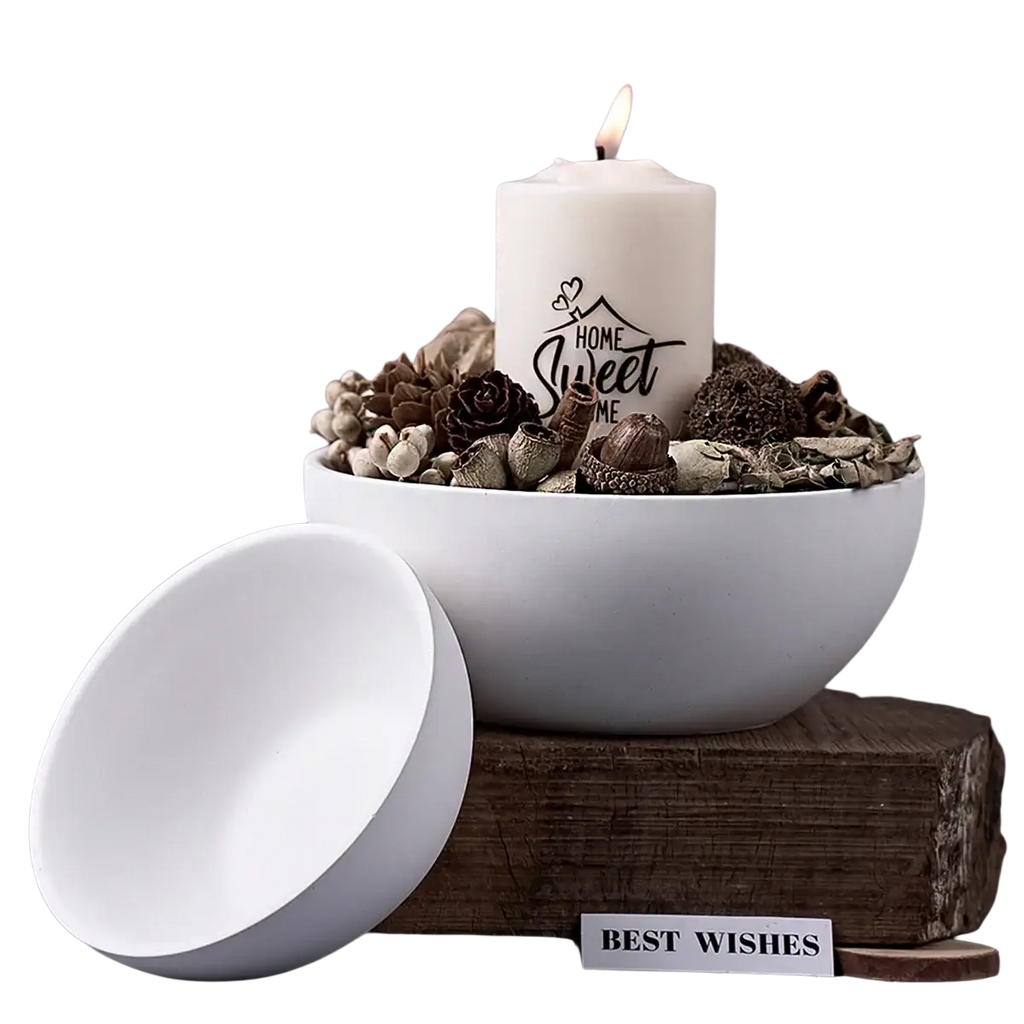 White ceramic bowl with matching lid holding lit candle and dried botanicals made using round silicone mold for concrete storage bowls and candles