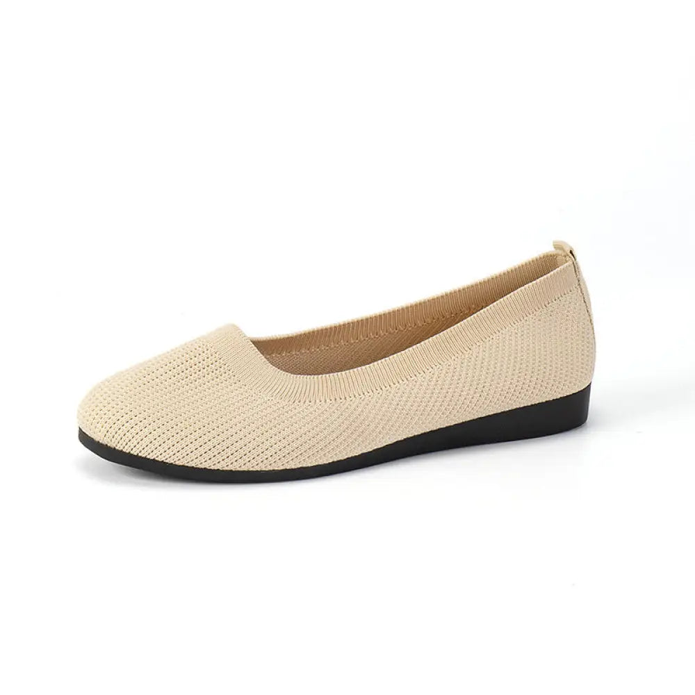 Women’s beige knit mesh slip on flats with round toe and black rubber sole for comfortable wear