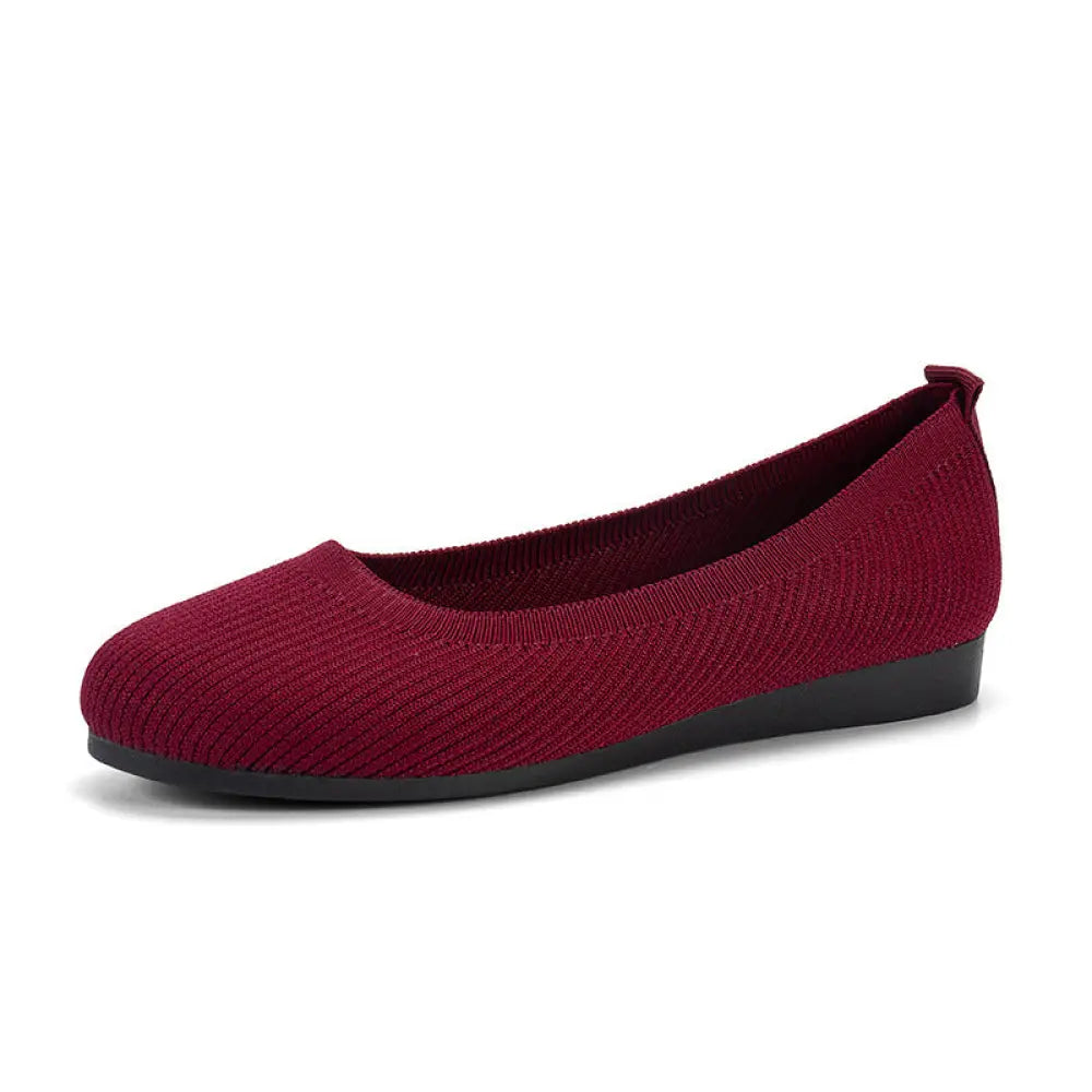 Women’s maroon round toe slip on flats made of knit mesh with a black rubber sole for comfortable wear