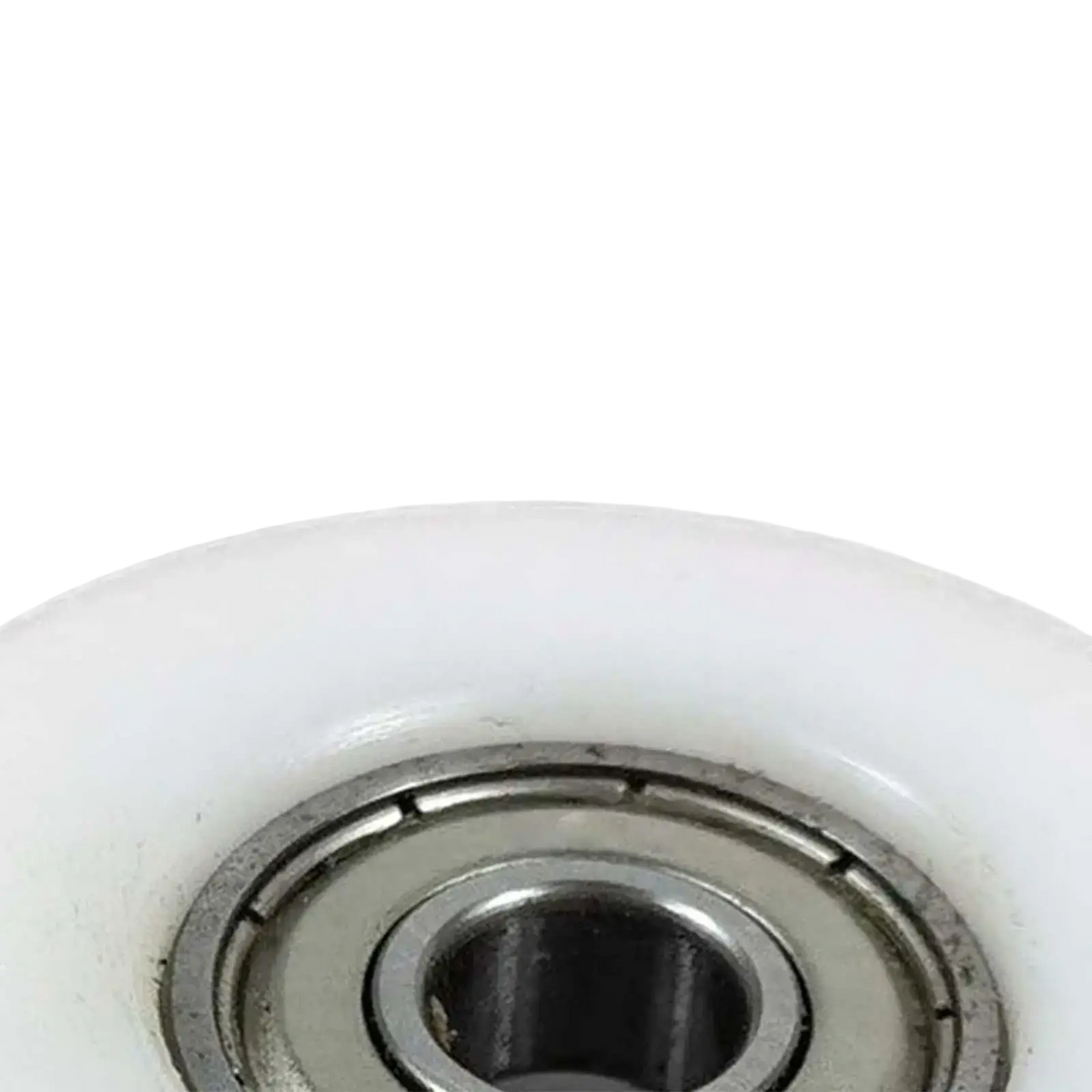 White plastic rowing machine bearing pulley wheel replacement with a metallic bearing assembly at its center