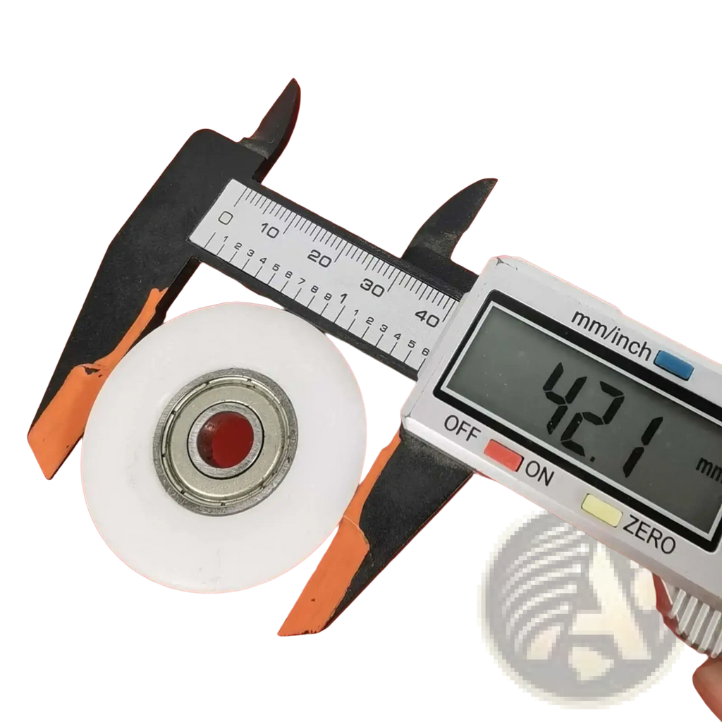 White plastic rowing machine bearing pulley wheel replacement with metallic center bearing held in black and orange calipers