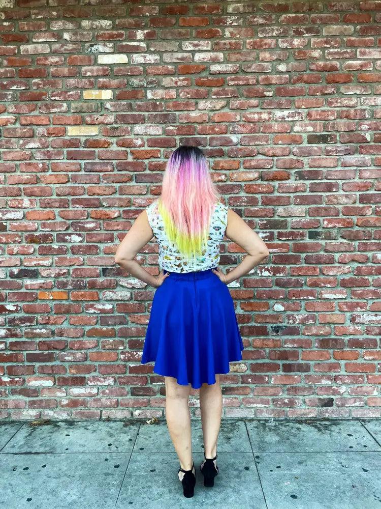 A vibrant royal blue retro a-line skater skirt with pockets and a flared hemline made from soft fabric