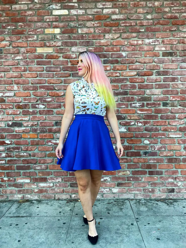 A vibrant royal blue retro a-line skater skirt with flared hem, structured waistband, and pockets