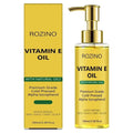 Gold pump bottle and yellow box of Rozino vitamin e care oil with clear glass body to soften dry skin