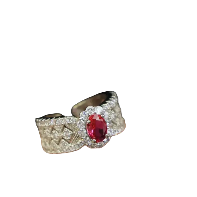 A silver ruby halo ring with an oval red ruby center and diamond pavé geometric pattern on the band