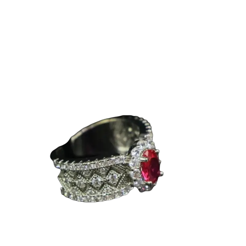 Silver ring with an oval-cut red ruby halo and a diamond pavé band featuring intricate geometric patterns