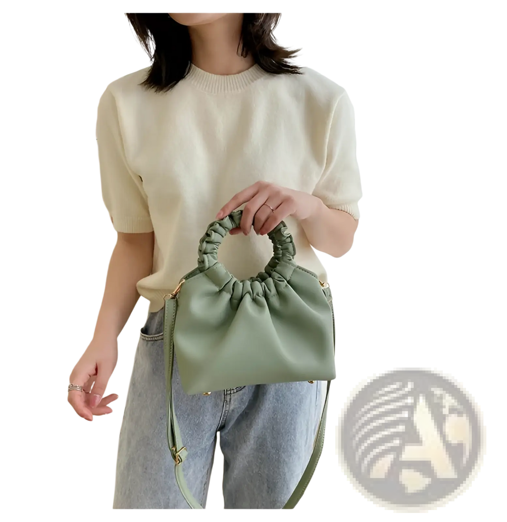 A soft sage green ruched leather bucket bag with gathered elasticated top handle and adjustable strap