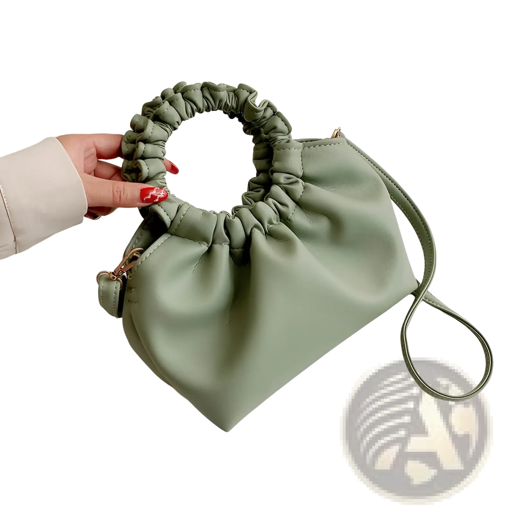 Ruched leather bucket bag in soft sage green with a gathered top handle and adjustable drawstring strap