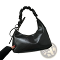 Black faux leather ruched shoulder bag with elasticated top handle and adjustable drawstring detail