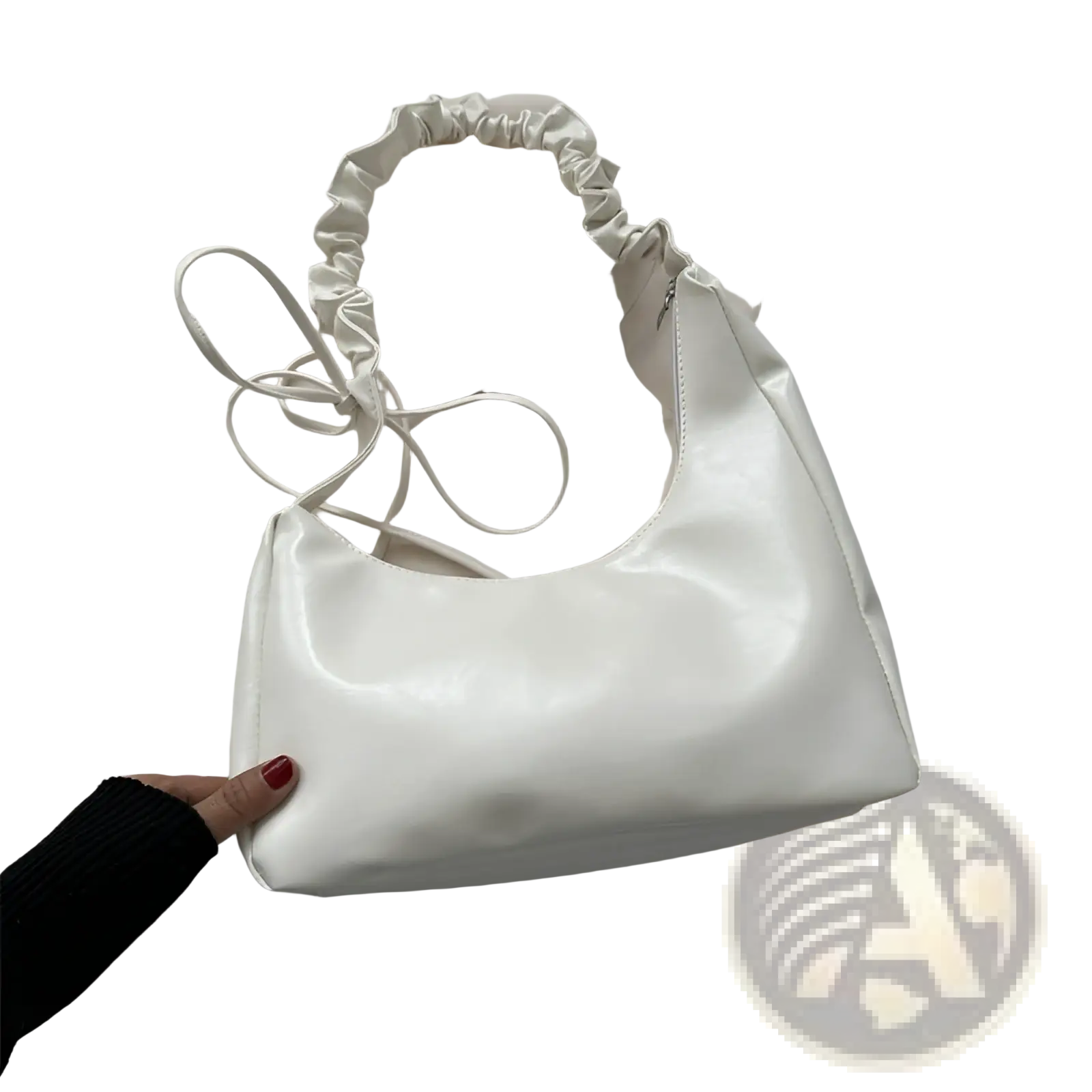 A sleek white patent leather ruched shoulder bag with top handle and matching drawstring tie