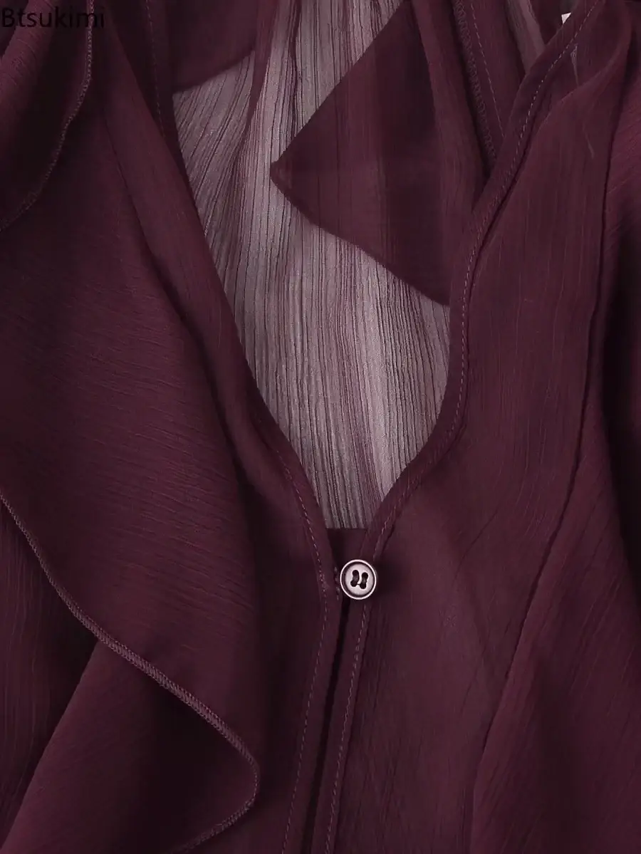 A maroon long sleeve ruffle shirt long chiffon blouse with sheer fabric, vertical pleats, and silver lululemon button