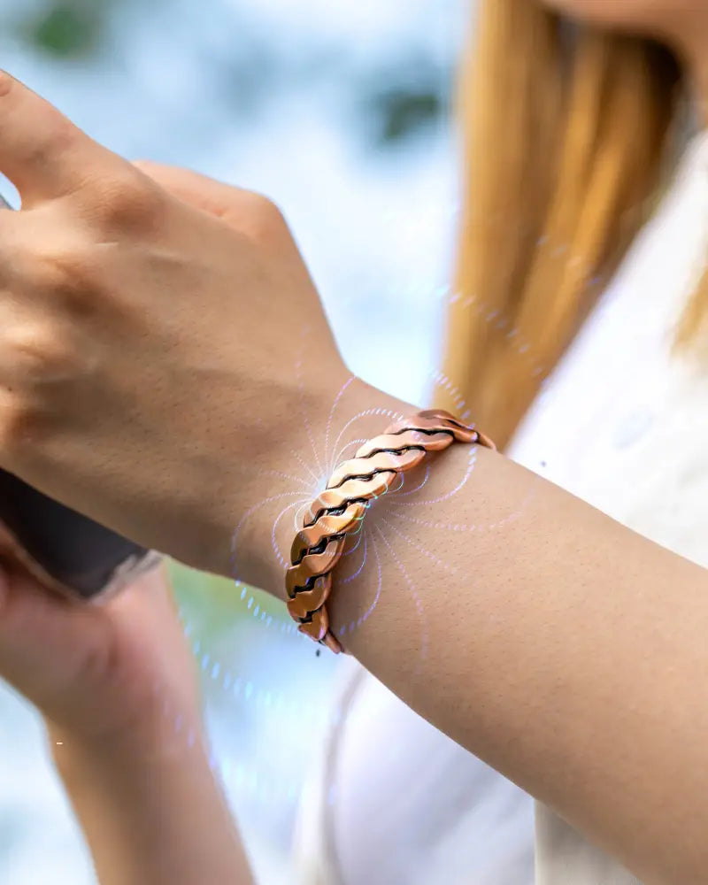 Rugged copper magnetic twist therapy bracelet featuring a copper-toned braided metal interlocking chain design worn on wrist
