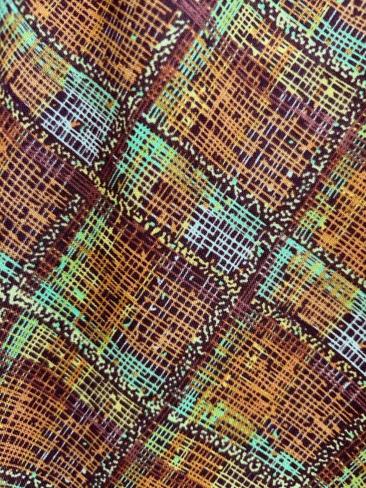 Rust plaid doris retro a-line cotton skirt with pockets featuring a vibrant woven diagonal pattern in brown orange teal and purple