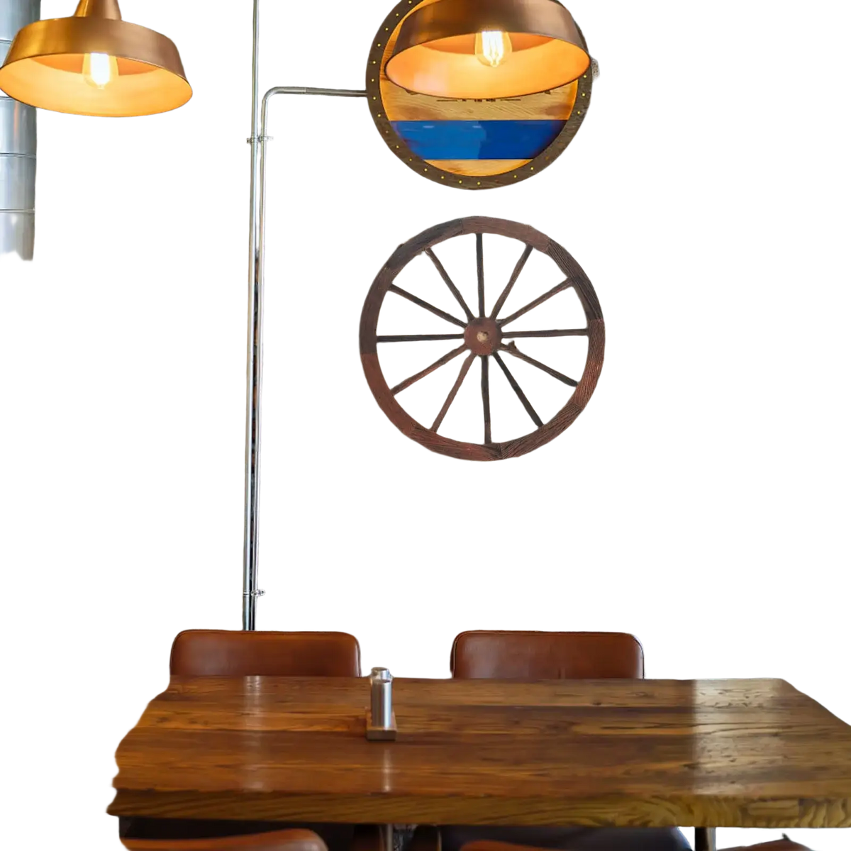 Rustic wooden wagon wheel wall decor mounted on a brick wall featuring natural wood and vintage style