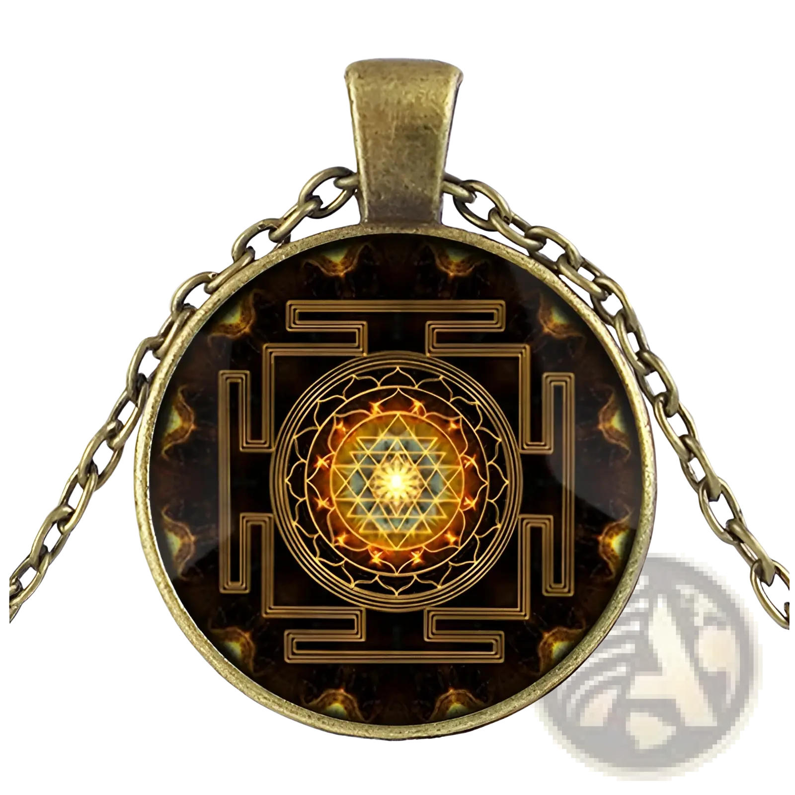 Antique brass pendant necklace with a circular glass cabochon featuring an intricate golden Sri Yantra design