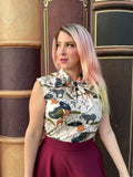 Sleeveless cotton blouse with white base and safari animal print featuring elephants giraffes lions and trees