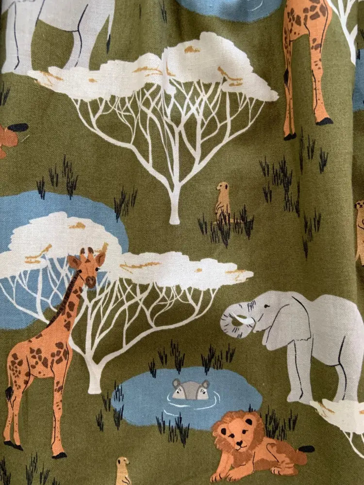 Olive green retro cotton dress with peter pan collar featuring safari print of giraffes elephants lions and trees