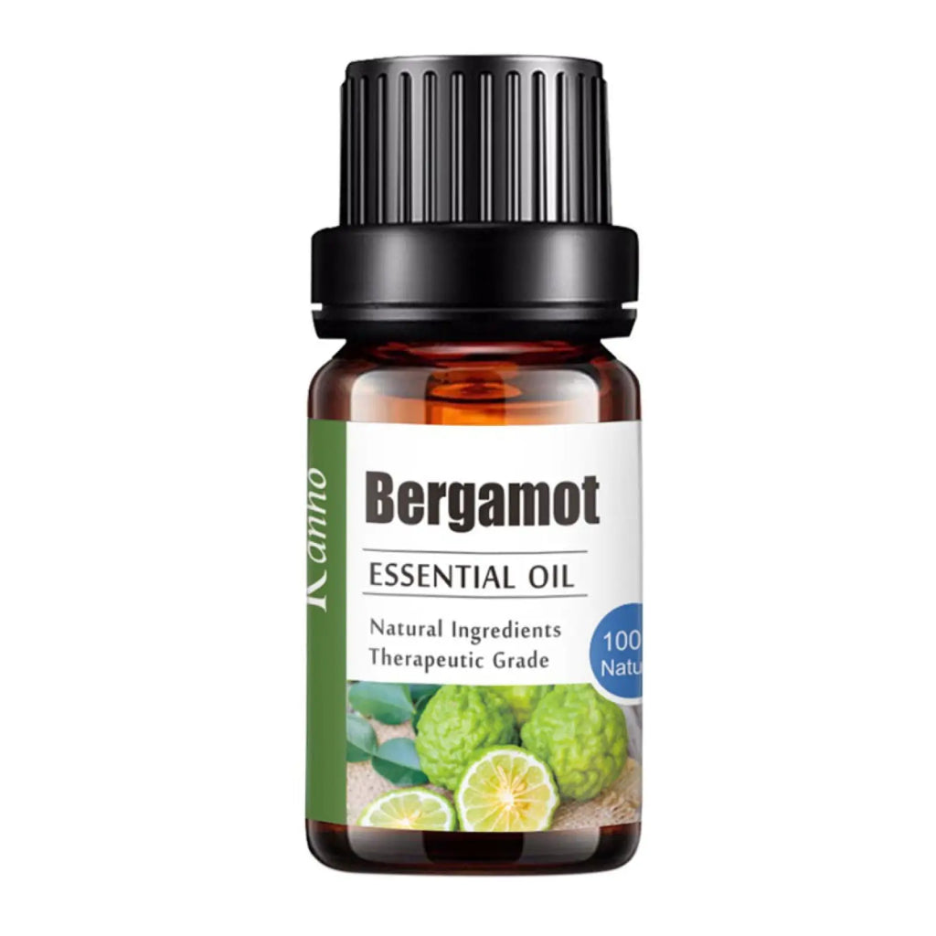 A small amber glass bottle of kamo bergamot essential oil with a black ribbed cap for aroma diffuser use