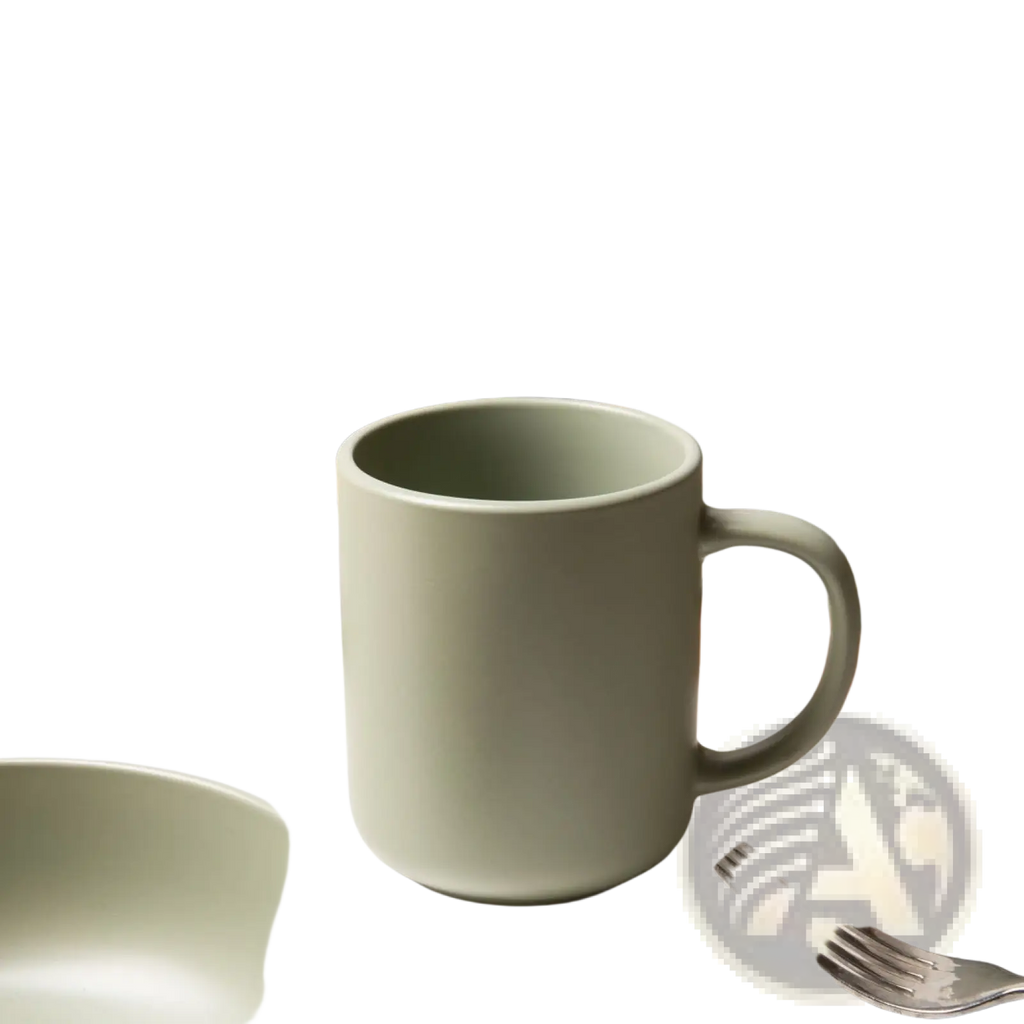 A matte sage green ceramic mug with a modern design and sturdy handle from a 12 piece stoneware dinnerware set for 3