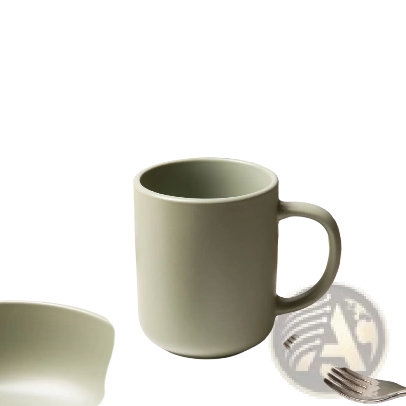 A matte sage green ceramic mug with a modern design and sturdy handle from a 12 piece stoneware dinnerware set for 3