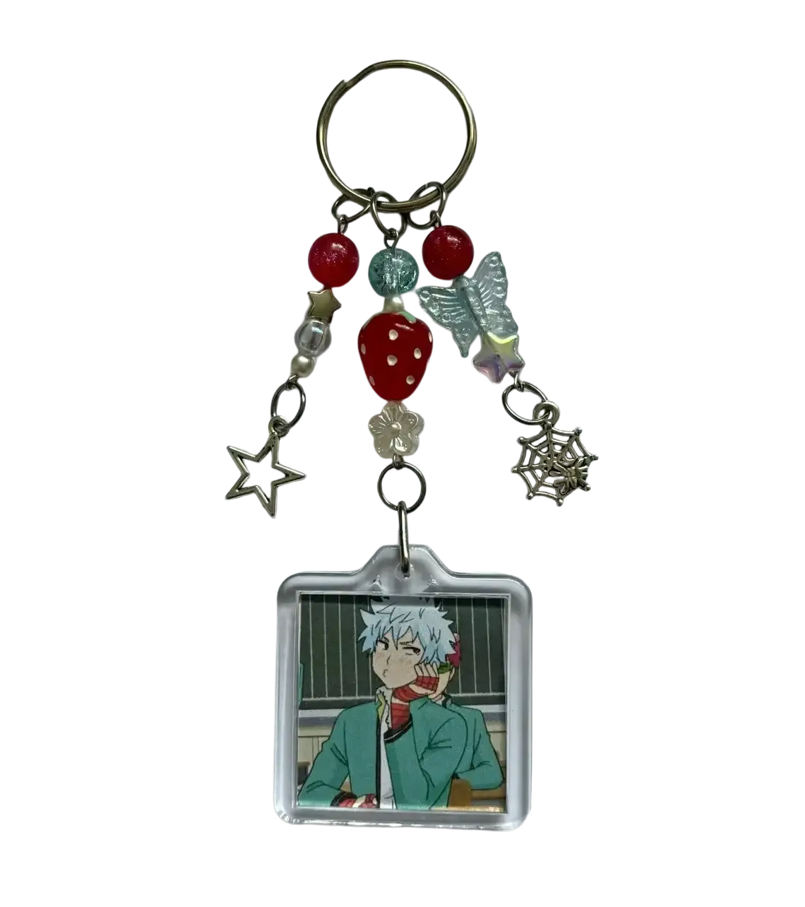 Clear acrylic saiki k beaded anime keychain with white hair character square portrait and dangling charms including stars and berries