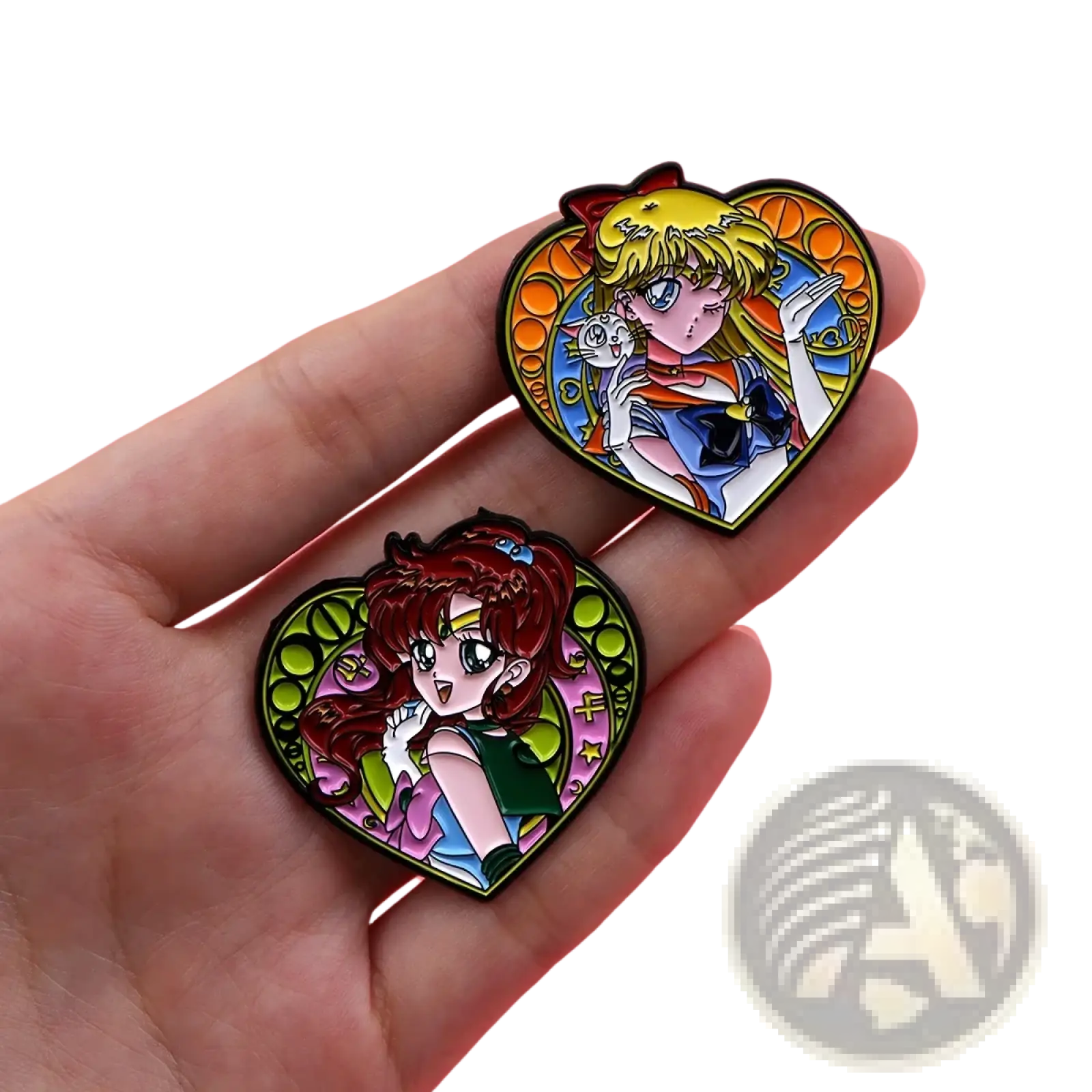 Two heart-shaped enamel pins featuring blonde and red-haired anime characters from sailor moon on pink background
