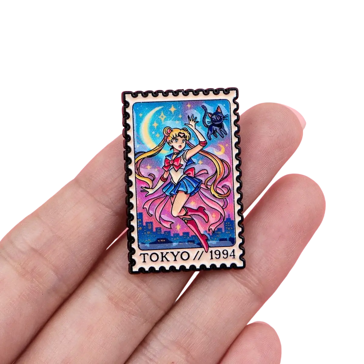 A vibrant enamel pin featuring sailor moon in a postage stamp design with tokyo skyline and starry night