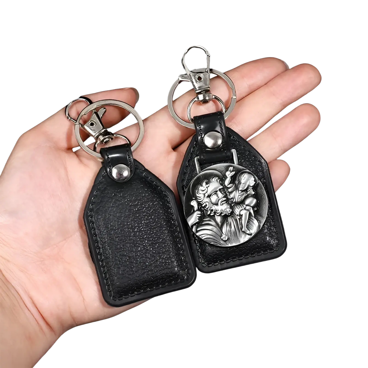 Black leather saint christopher keychain with silver-toned medallion depicting a religious scene in antique bronze finish