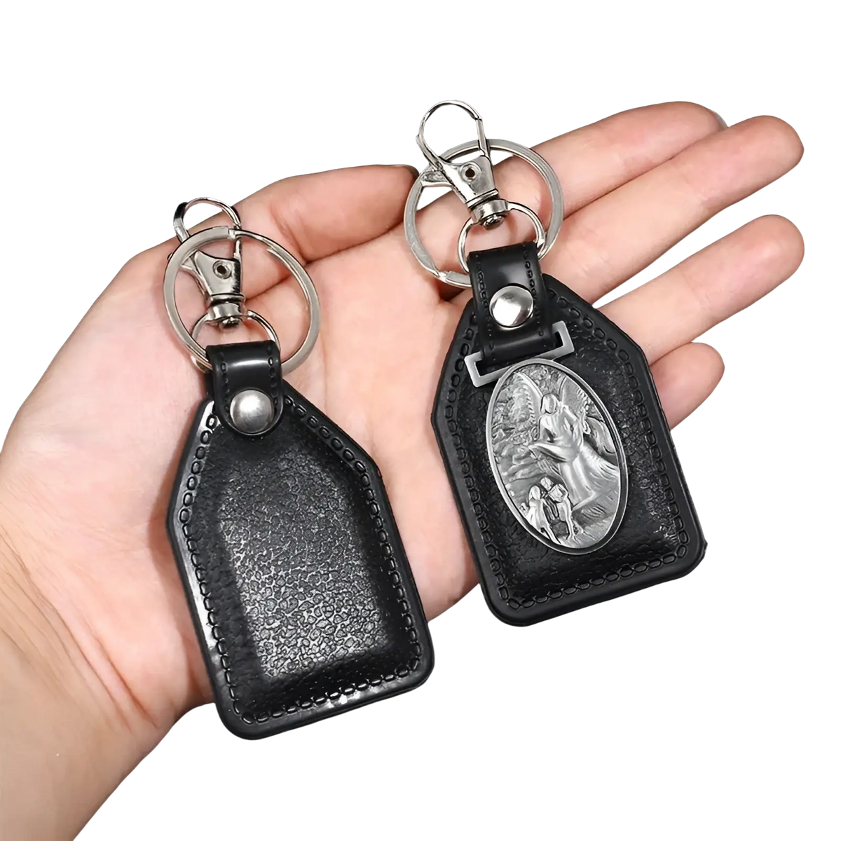 Black leather saint christopher keychain with silver-toned clasp and oval medallion featuring religious scene