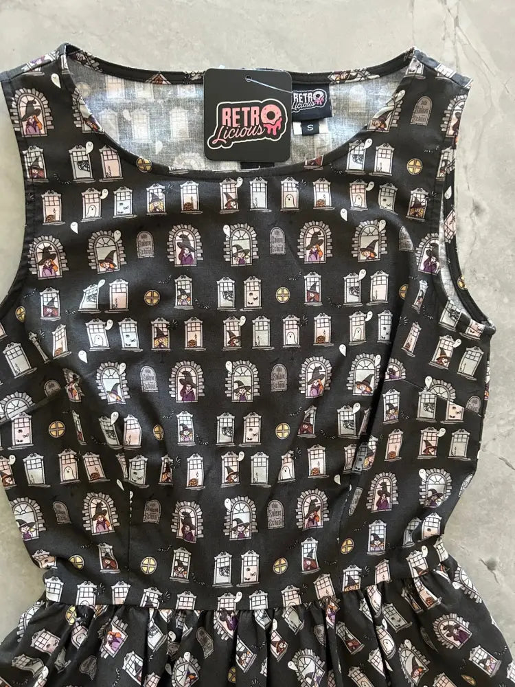 Black sleeveless cotton dress with vintage witch window print designed by retro liquor in salem school style
