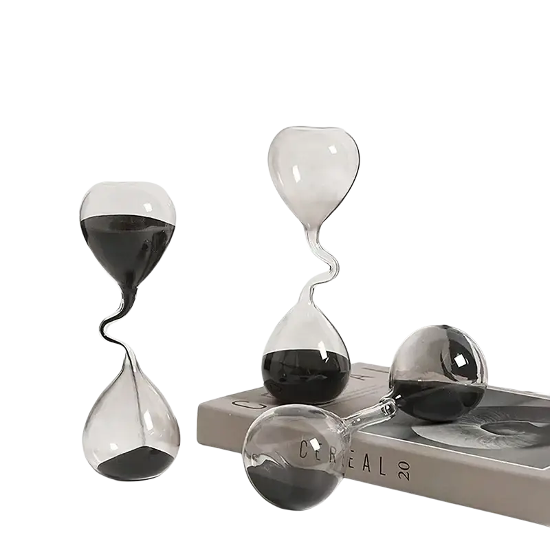 Clear glass hourglass timer with black sand featuring twisted and spherical designs for home decoration