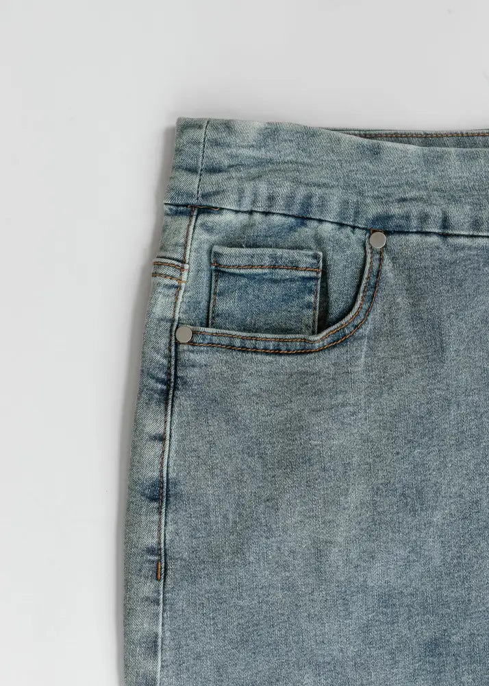 Sandra classic light wash straight denim midi skirt with light-wash denim, front pocket, silver rivets, and contrasting stitching
