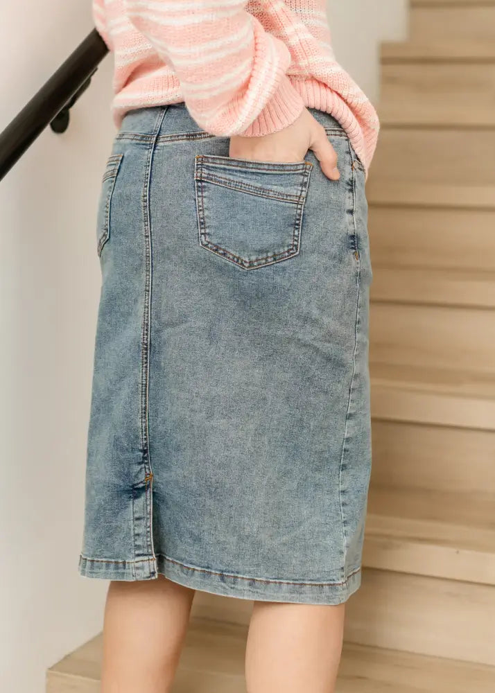 Sandra classic light wash straight denim midi skirt showing the back side with a classic pocket and straight hem