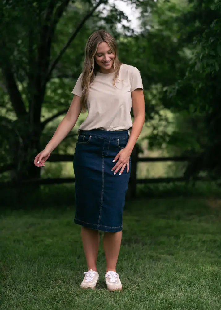 Sandra dark wash denim midi pencil skirt mid-thigh length in classic dark blue with visible stitching and button closure