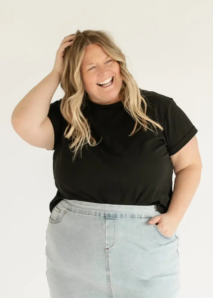 Black short-sleeved t-shirt with relaxed fit and ribbed neckline paired with sandra light wash denim stretch midi skirt