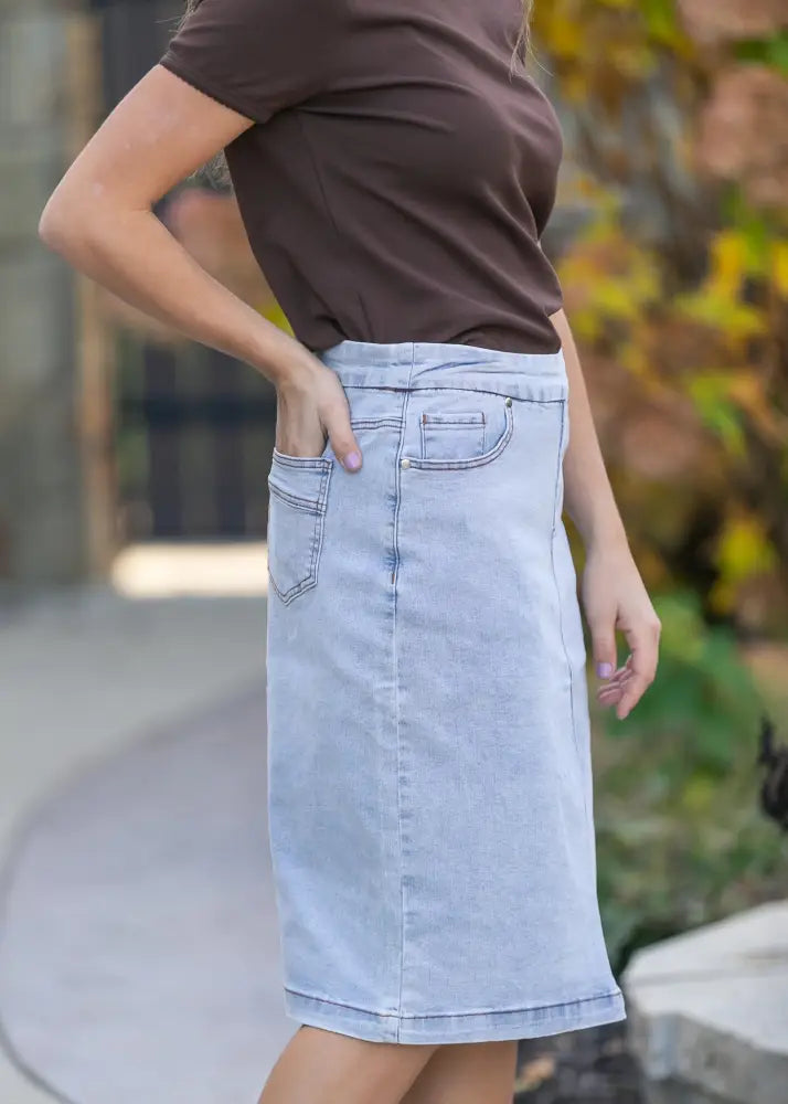Sandra light wash denim stretch midi skirt in light blue with front pockets and a straight hem